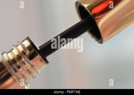 woman hand with finger holds professionall tool black lash mascara brush closeup Stock Photo