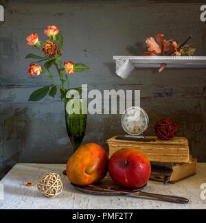 still life with mango fruits, books and a bunch of roses. vintage. Stock Photo