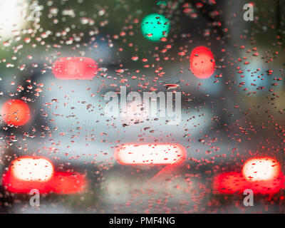 view from the inside onto rain drops on the windscreen of the car Stock Photo