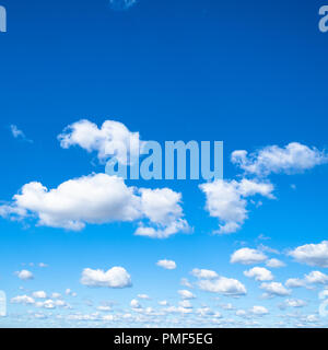 little puffy clouds in blue sky in sunny september day Stock Photo