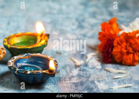 Happy Diwali - Colorful Clay Diya lit during Deepavali festival of lights, selective focus Stock Photo