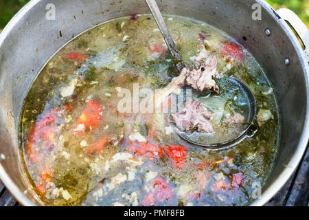 https://l450v.alamy.com/450v/pmf8fb/top-view-of-cooking-central-asian-shurpa-soup-from-meat-and-large-sliced-vegetables-in-pot-outdoors-pmf8fb.jpg