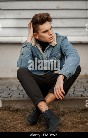 Premium Photo | Good-looking young man with hairstyle with stylish blue denim  jacket in pink fashionable t-shirt poses near old wooden brown wall in  city. glamour urban sweet guy in trendy casual