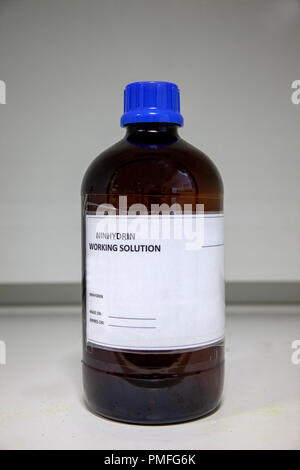 Glass bottle for containing Ninhydrin Working Solution to be used on porous surfaces for the enhancement of latent fingerprints using the chemical Stock Photo