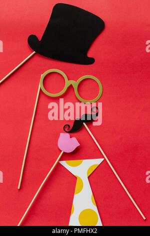 Paper props for holidays and parties on red background Stock Photo