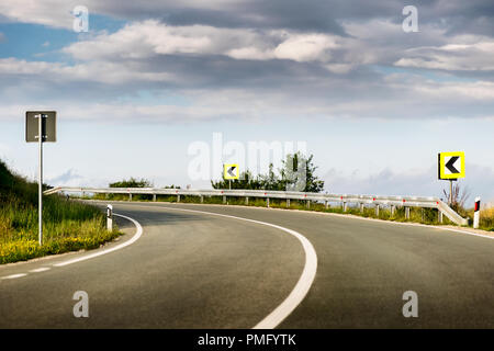 Empty asphalt road winding through beautiful mountains Stock Photo