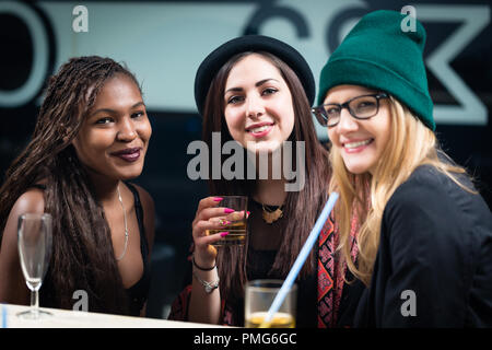 Female diverse friends enjoying drinks at party Stock Photo
