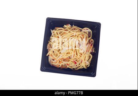 Takeaway or takeout container of prepared food Thai Chili noodles in black plastic on white background Stock Photo