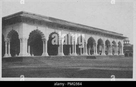 Black and white photograph on cardstock, with an image of the Diwan-i-Aam (Hall of Audience) a room in Delhi's Red Fort, where the Mughal Emperors received public audiences, shot from a low, slightly angled perspective, showing a single story, flat-roofed structure, consisting of a long collonade, with multilobed arches, supported on double columns, likely collected as a tourist souvenir during a trip to India, 1910. () Stock Photo