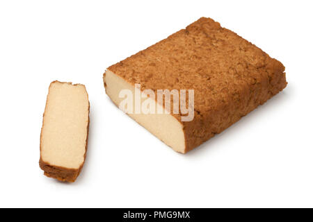 Piece of smoked tofu and a slice isolated on white background Stock Photo