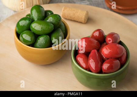 Bowls with red and green Italian Bella olives as snack food Stock Photo