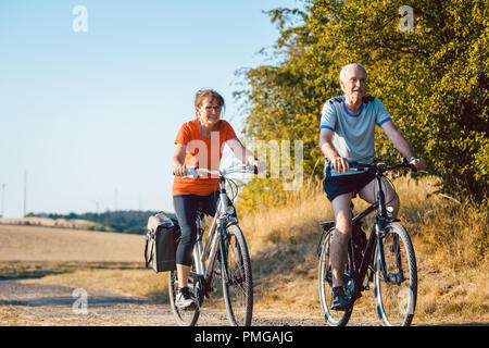 Senior couple riding their bicycles for better fitness Stock Photo