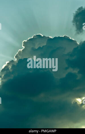 dramatic clouds with rays of light from behind it Stock Photo