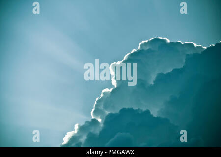 dramatic clouds with rays of light from behind it Stock Photo