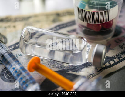 vials with different substances over dollar, concept of copayment Stock Photo