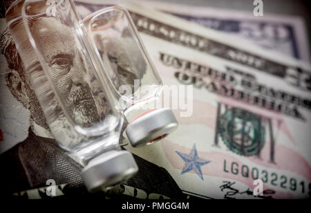 vials with different substances over dollar, concept of copayment Stock Photo