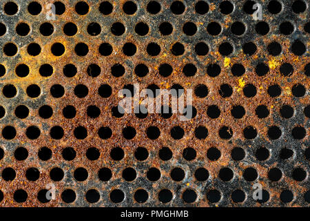 rusty and perforated metal background that occupies the entire cuador Stock Photo