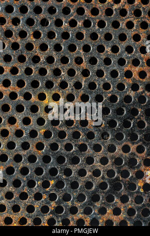 rusty and perforated metal background that occupies the entire cuador Stock Photo