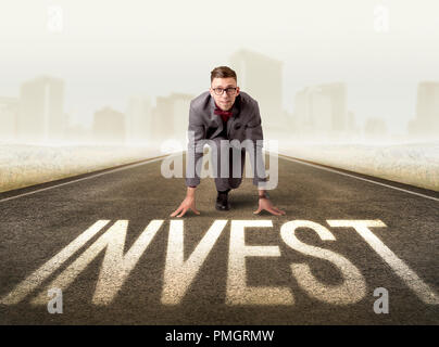 Young determined businessman kneeling before profit sign Stock Photo