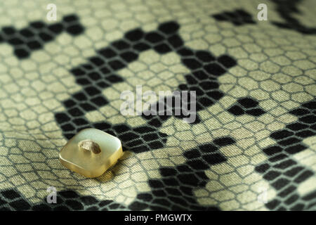 closeup detail shot of button on woman shirt clothes Stock Photo