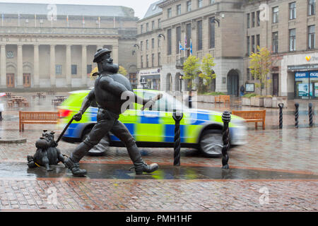 8ft bronze figure of Desperate Dan statue;  Wild west famous character in the British comic magazine The Dandy.  Dundee, Scotland. UK Weather Sept 2018.  Rainy start to the day in the city centre with heavy rain forecast for later in the day.  Credit; MediaWorldImages/AlamyLiveNews Stock Photo