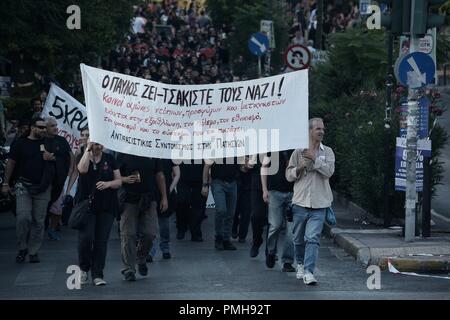Athens, Greece. 18th Sep, 2018. Protesters seen matching on the street while holding banners during the clashes.Protest and clashes against the murder and marking the fifth anniversary of Pavlos Fyassas, who was short by neo-Nazi in the port city of Piraeus. Credit: Giorgos Zachos/SOPA Images/ZUMA Wire/Alamy Live News Stock Photo