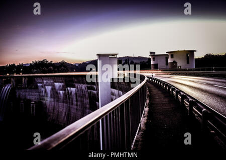 Long exposure shot of the Schiffenen dam in the county of Fribourg, in Switzerland, with vehicle light trails on the side Stock Photo