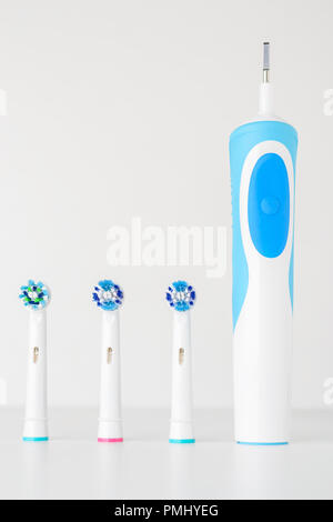 Close up of electric toothbrush and spare brush heads on white background Stock Photo