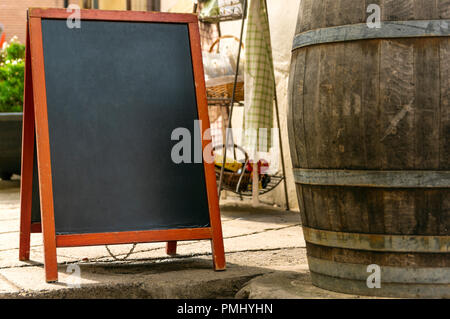 Blackboard standing on sidewalk in front of restaurant Stock Photo