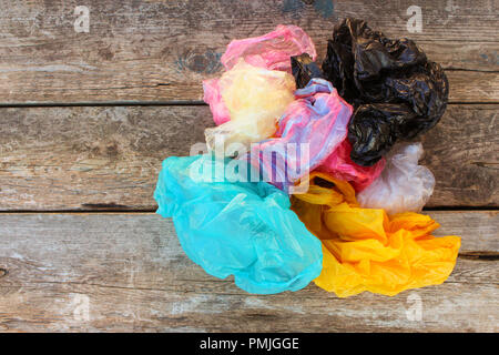 Different plastic bags on old wooden background. Top view. Stock Photo