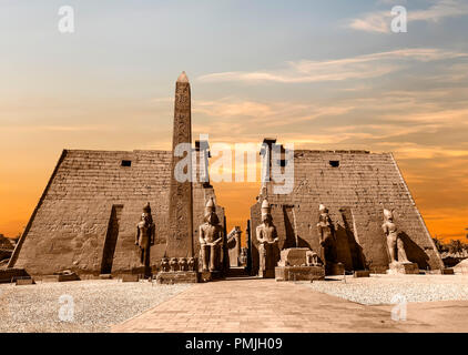 Entrance to Luxor Temple at sunset, a large Ancient Egyptian temple complex located on the east bank of the Nile River in the city today known as Luxo Stock Photo