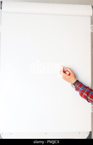 Man writes a red marker on a white board. Office concept Stock Photo