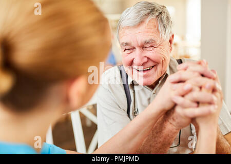 Old man gets comfort and hope from a nursing wife and is happy Stock Photo
