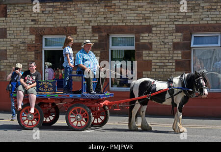 Gypsy Traveller family riding on cart. Appleby Horse Fair 2018. The Sands, Appleby-in-Westmorland, Cumbria, England, United Kingdom, Europe. Stock Photo