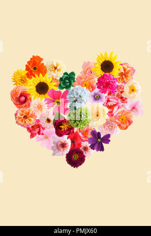 Heart symbol made of crepe paper flowers isolated on yellow background Stock Photo