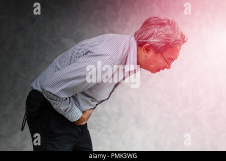 Asian senior office male suffering pain from stomach ache diarrhea expression. Stock Photo