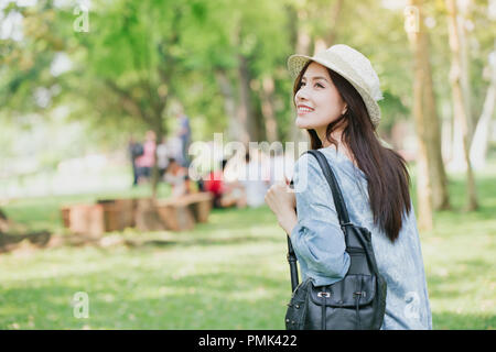 teen with shoulder bag summer walking in the green park Stock Photo