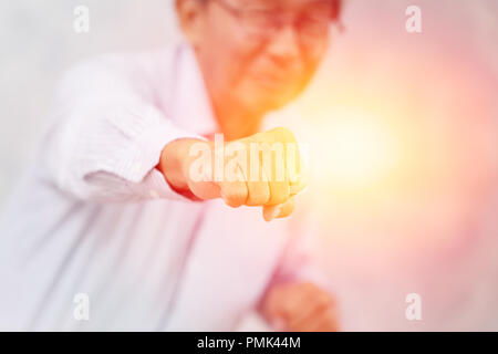 ้Healthy elder strong good health fist punch fighting with disease and sickness Stock Photo