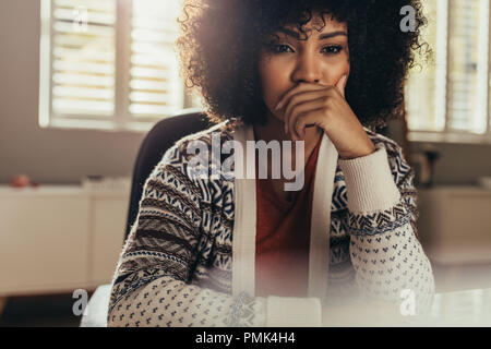 Young female architect thinking about new ideas. Woman designer sitting in office and working on new project. Stock Photo