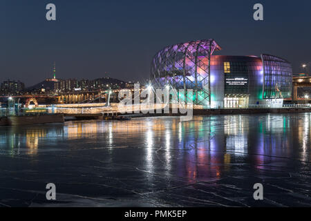 SEOUL, SOUTH KOREA - JAN 22, 2018: Some Sevit building and N Seoul tower at night with reflection on frozen river Stock Photo