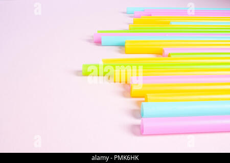 Plastic Drinking Straws on Pink Background Stock Photo