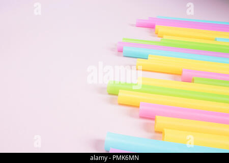 Plastic Drinking Straws on Pink Background Stock Photo