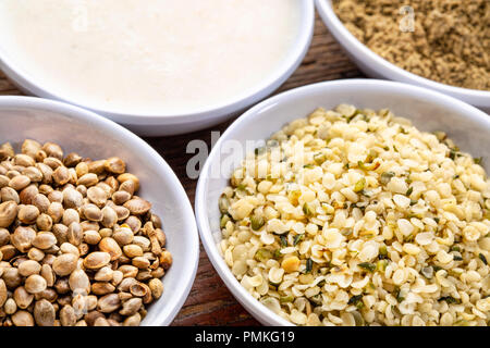 hemp seeds, hearts, milk and protein powder - a set of small ceramic bowls Stock Photo