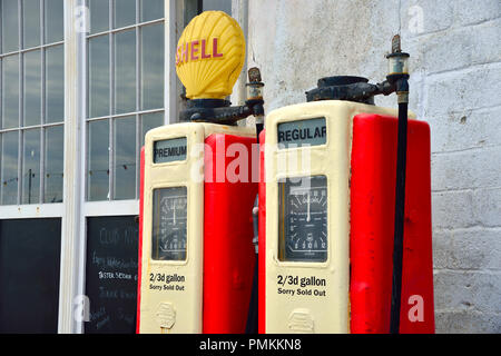 Vintage petrol pumps on the quayside road in the picturesque seaside village of St Mawes on the Roseland Peninsula, Cornwall, South West England, UK Stock Photo