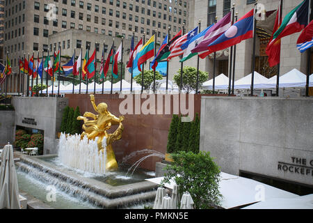 New York, USA – August 23, 2018: The golden Prometheus statue (ancient Greek god Prometheus) at Rockefeller Center with flags in Manhattan, New York,  Stock Photo