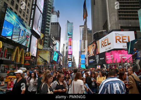 New York, USA – August 20, 2018: Crowded with many people walking Times Square with huge number of LED signs, is a symbol of New York City in Manhatta