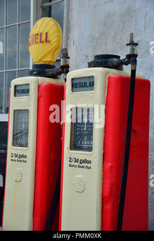 Vintage petrol pumps on the quayside road in the picturesque seaside village of St Mawes on the Roseland Peninsula, Cornwall, South West England, UK Stock Photo