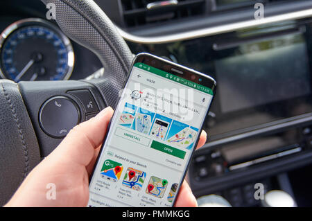 MONTREAL, CANADA - AUGUST 8, 2018: Waze application on a cell phone screen in a car. is one of the popular gps navigation services. Stock Photo