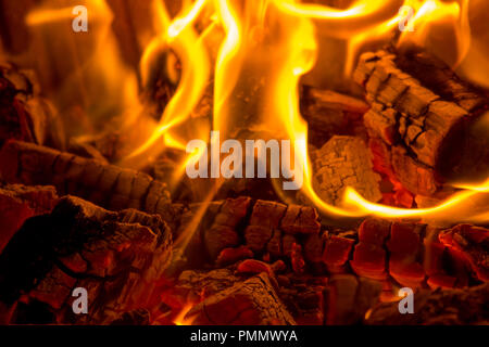 Burning close-up wood coals in the fireplace Stock Photo
