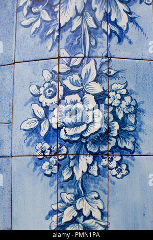 Two tone blue and white traditional hand painted ceramic tiles showing stories and designs outdoors on the street in Funchal Madeira Stock Photo